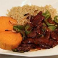 Zesty Steak · Lean steak with onions, peppers over sweet potatoes, and brown rice with BBQ sauce.