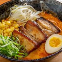 Spicy Pork Belly Ramen · Ramen noodles with braised pork belly, soft boiled egg, corn, and scallion in creamy spicy b...