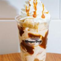Dulce Split Dazzler Sundae · Dulce de leche ice cream layered cream layered with bananas and warm caramel topped with whi...