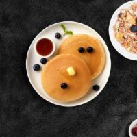 Blueberry Pancakes · Fluffy pancakes cooked with care and love served with blueberries, butter and maple syrup. S...