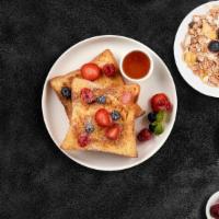 Berry French Toast · Fresh bread battered in egg, milk, and cinnamon cooked until spongy and golden brown. Topped...