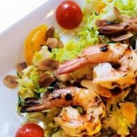 Insalata Di Gamberi · Grilled shrimp, shredded brussel sprouts, sliced orange, cucumbers, cherry tomatoes, toasted...