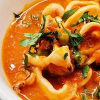 Calamari · braised in spicy tomato sauce with green peas