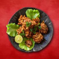 Veggie Fritter Fave · Garden fresh assorted vegetable pieces coated in seasoned gram flour batter and deep-fried.