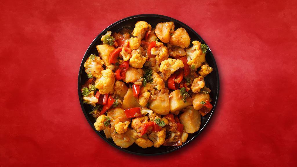 Cauli Potato Story · Pieces of cauliflower and potato cooked with vibrant flavors of fresh tomatoes, onions, ginger, garlic, and cumin.