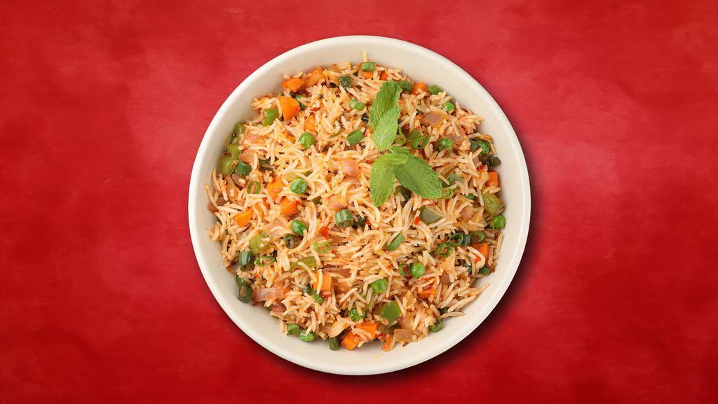 Veg Biryani Sensation · Long grain basmati rice cooked with garden fresh vegetables in a blend of Indian exotic spices and herbs.