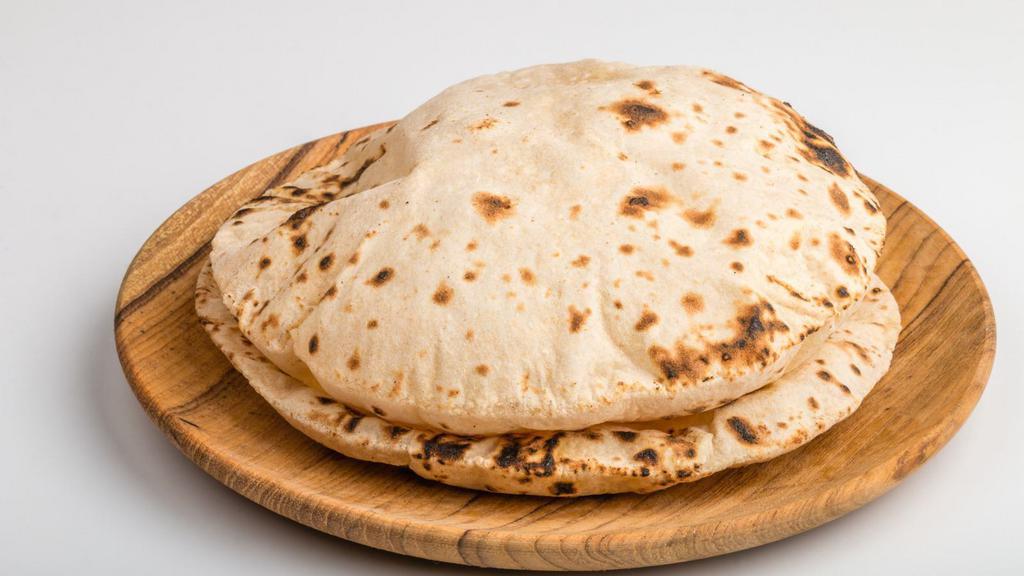 Tawa Roti · Light, whole wheat, griddled flatbread cooked until puffed on a traditional tawa pan.