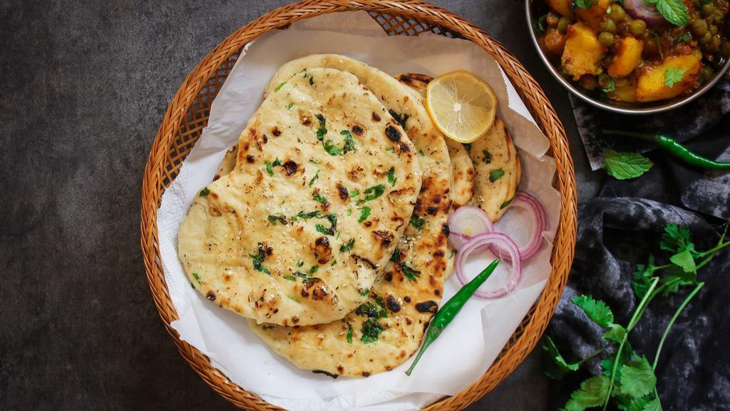 Naan · Fresh, puffy flat bread freshly baked to order.