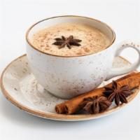Masala Chai (Spiced Milk Tea) · Aromatic Indian tea leaves steep in milk with warming spices including green cardamom, cinna...