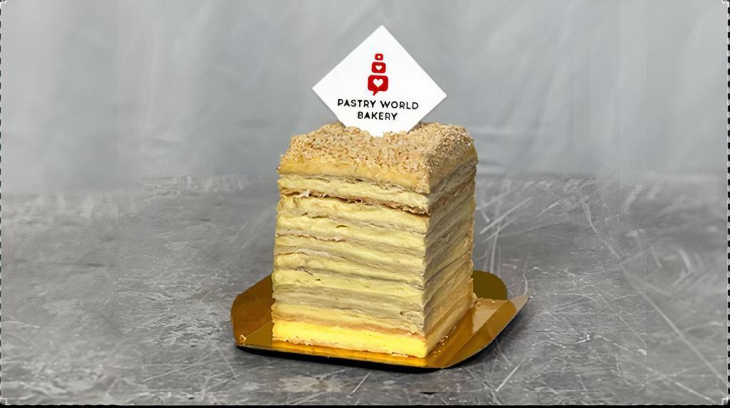 Napoleon Cake Slice · Thinly rolled puffed pastry (there are about 256 layers) with creamy vanilla custard between. Ingredients: butter, sugar, egg, flour, baked powder, salt, vanilla, cream, milk, wine vinegar.