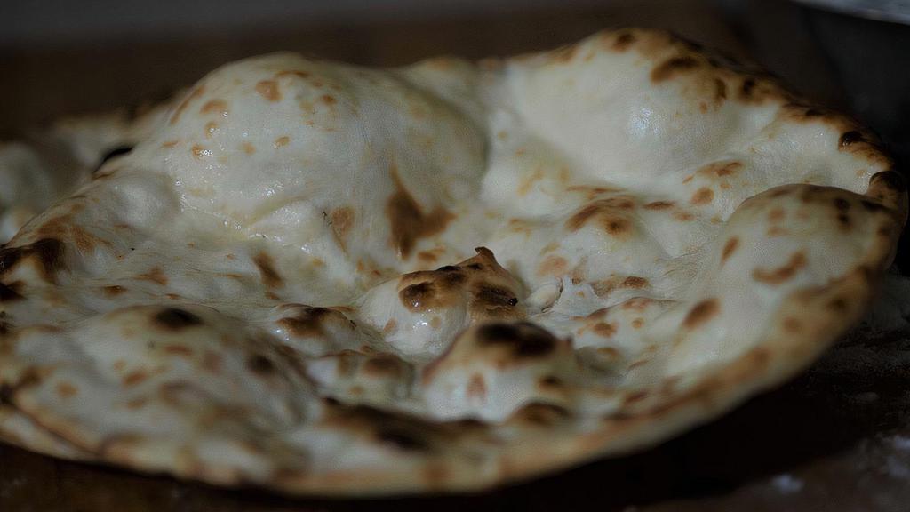 Naan · Soft flour bread baked in clay oven.