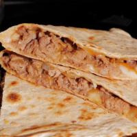 Beef Bulgogi Quesadilla · Korean marinated beef peppers and onion with shredded cheddar cheese on a white flour tortil...