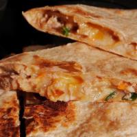 Chicken Quesadilla · Marinated chicken peppers and onion with shredded cheddar cheese on a white flour tortillas