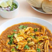 Misal Pav · A spicy lentil (turkish gram) and potato chili served with a side of fresh butter-toasted ro...