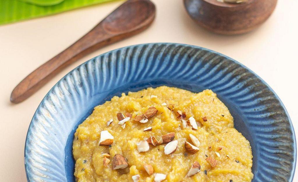 Moong Dal Sheera  · A rich sweet lentil delicacy seasoned with spices like nutmeg and cardamom, topped with almond flakes.