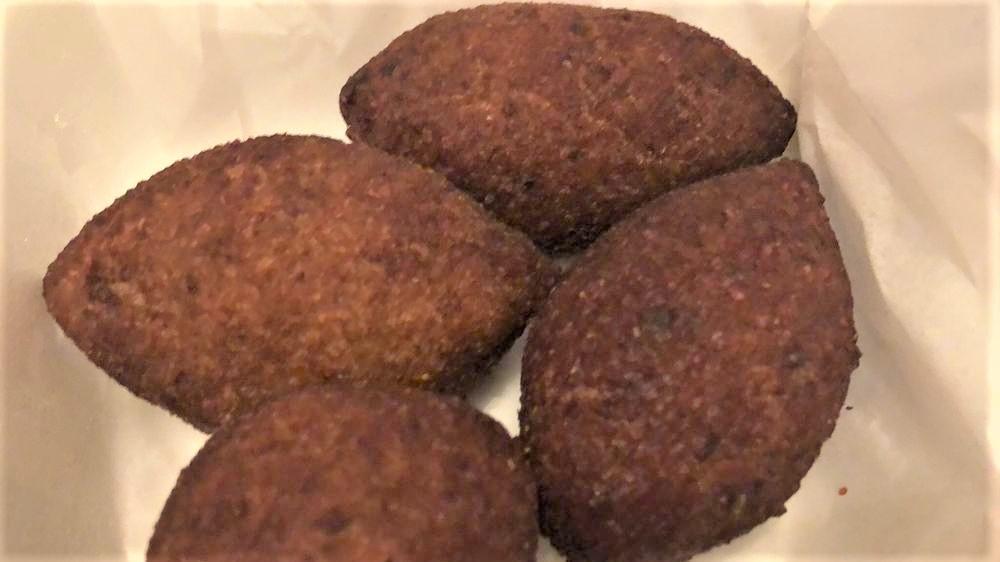 Kibbe · Meat and bulgur shells stuffed with ground beef, onions, & nuts.
