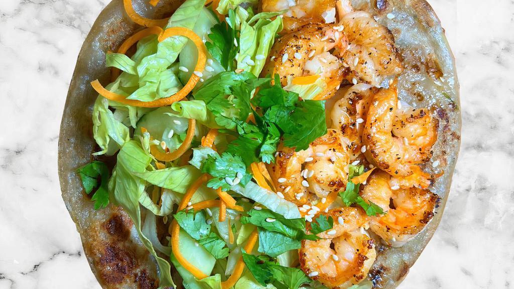 Shrimp Scallion Pancake Wrap · Our signature flaky, crispy scallion pancake filled with grilled shrimp, sautéed onions, pickled carrots, fresh cucumbers, lettuce, and sesame seed. Your choice of sauce on the side.