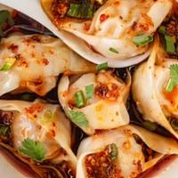Pork Dumplings · 10 pieces dumplings in chili oil with scallions.