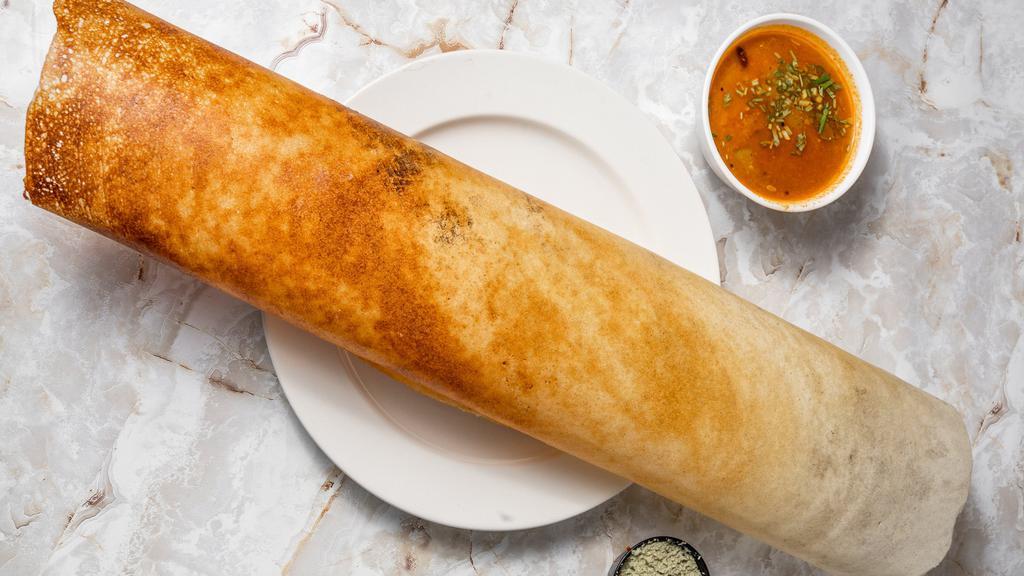 Masala Dosa · From the Coromandel Coast. A paper-thin rice & lentil crêpe stuffed with spiced potatoes & peas, served with coconut chutney.