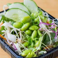 Side Salad · Romaine lettuce, cucumbers, shaved carrots, cabbage, edamame, scallions, creamy ginger dress...