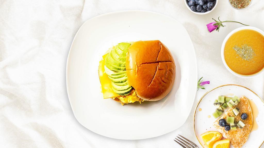 Avocado, Egg And Cheese Sandwich · Avocado, scrambled egg, and cheddar cheese served on a bread.