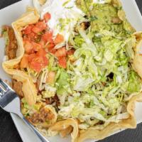 Taco Salad · Served in a crispy flour tortilla bowl with refried beans, lettuce, sour cream, shredded che...