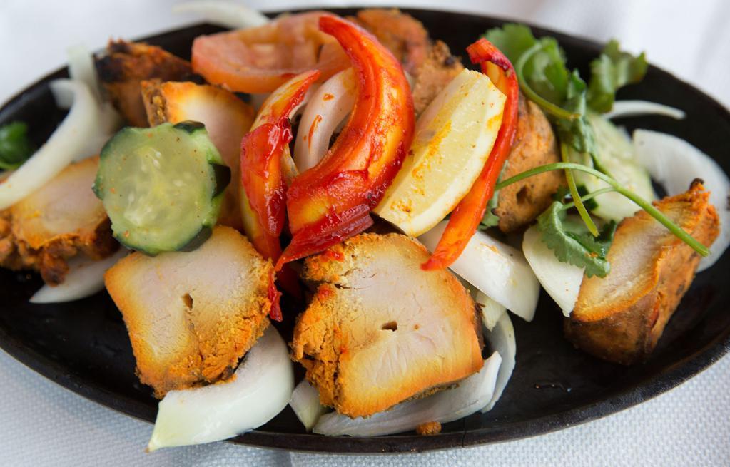 Chicken Tikka · Boneless chicken marinated in herbs & spices, BBQ over charcoal.