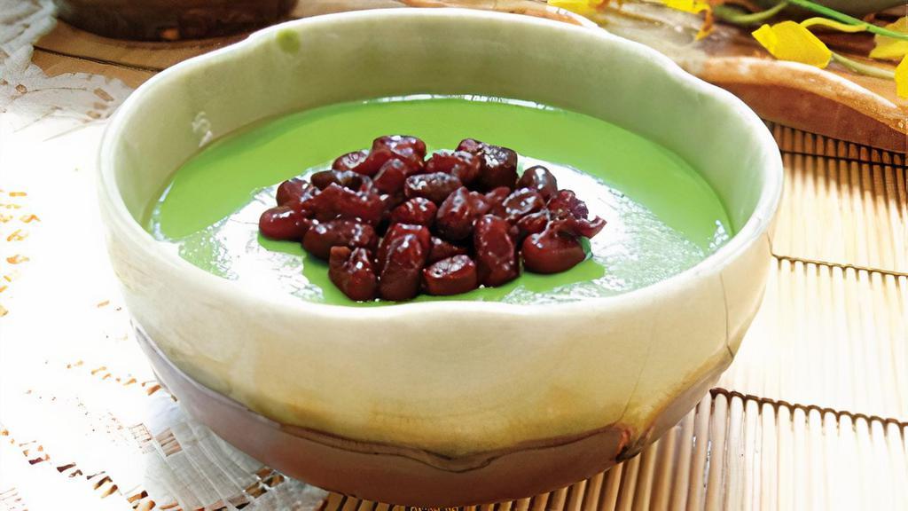 Matcha Pudding With Red Beans · Matcha pudding topped with red bean, milk creamer on the side.