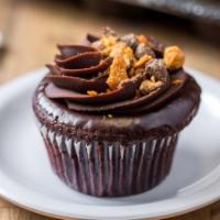 Ron Bennington · chocolate cake with a peanut butter filling, topped with chocolate ganache and crushed butte...