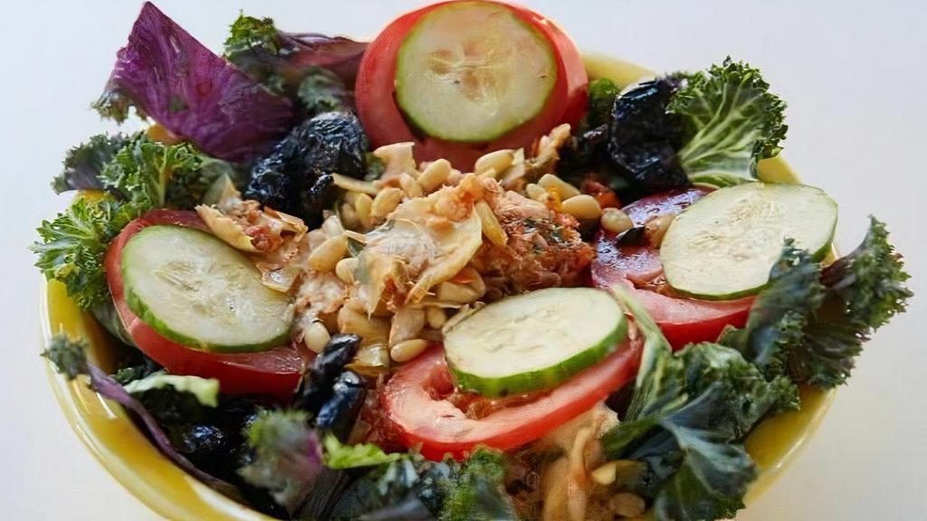 Kale Salad · Marinated artichokes, Roma tomatoes, kale, cucumbers, oil cured black olives, pine nuts and white balsamic.