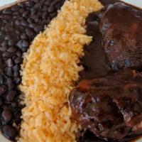 Pollo Con Salsa · Chicken with choice of green, or mole sauce with rice, and beans.