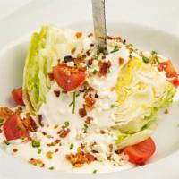 Iceberg Wedge · With cherry tomatoes, bacon bits, and blue cheese dressing.