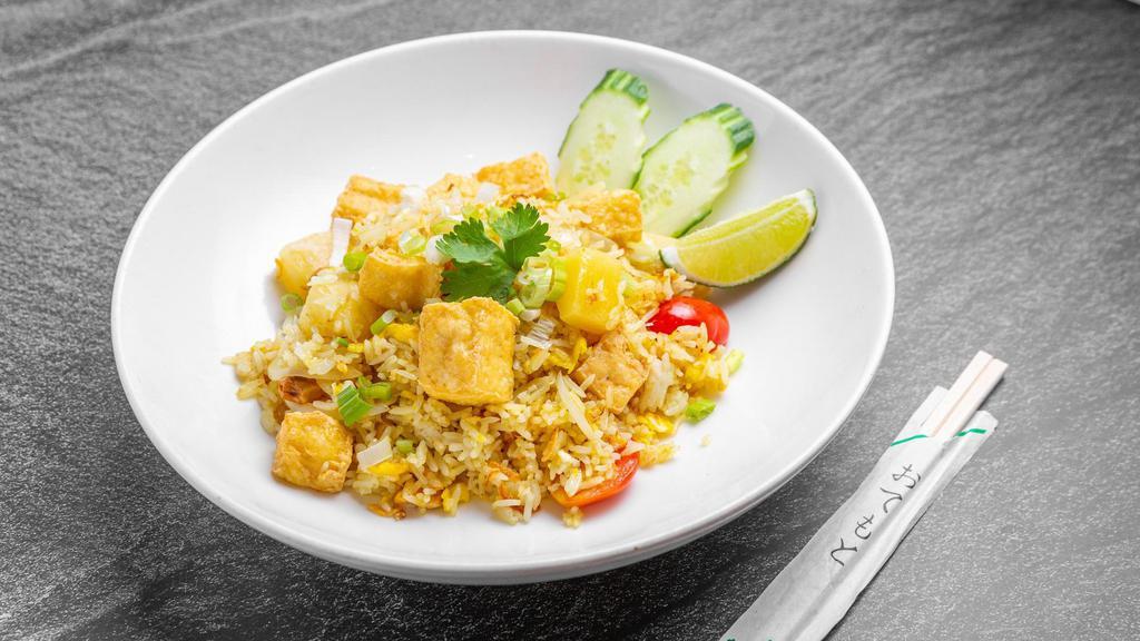 Pineapple Fried Rice · Steamed jasmine rice with egg, garlic, onion, pineapple, scallion, tomatoes, cashew nuts, curry powder and crispy shallot with your choice of protein.