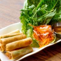 Chả Ram - Crispy Shrimp Roll (8) · Scallion in wonton rice paper served with lettuce and herbs.