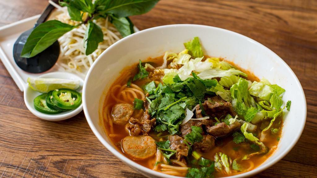 Bún Bò Huế · Hot and spicy. Famour beef pho. Famous beef stewed, meatball and brisket in spicy lemongrass soup. Beef broth and rice noodle. Topped with scallion, onion and cilantro. Served with bean sprout, jalapeno, basil, and lime or lemon.
