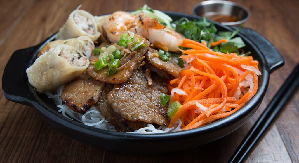 Bún Shop · #1 favorite. Grilled pork chop, grilled shrimp and spring roll. Rice vermicelli topped with scallion and fried shallots. Served with cucumber, mint, cilantro, lettuce, pickled daikon, carrot and peanuts.