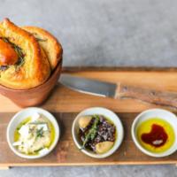 Olive And Rosemary Bread · Served in a flower pot with a dip trio: Evoo, aged balsamic and cracked pepper, Sundried tom...