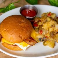E.C. Sandwich · Bacon, two over easy eggs, american cheese on a house made brioche bun served with home fries.