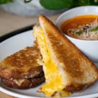 Grilled Cheese & Tomato Bisque · Swiss, cheddar, and american cheese on thick cut sourdough bread served with creamy tomato b...