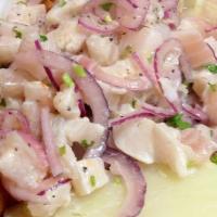 Ceviche De Pescado · Diced fish fillet peruvian style marinated in lemon juice and hot pepper.