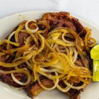 Chuleta De Cerdo Asada · Roasted pork chop.