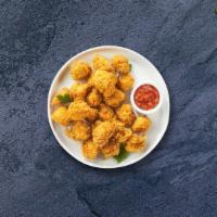 Chicken Popcorn · Bite-size pieces of chicken breaded and fried until golden brown.