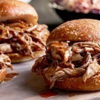 Pulled Pork · Beer braised pulled pork on a garlic buttered roll, topped with a sweet slaw and sweet potat...