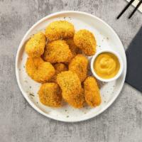 Chicken Nugget · Bite sized nuggets of chicken breaded and fried until golden brown. Served with your choice ...