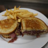 Reuben · Hot corned beef on grilled rye with sauerkraut and melted swiss cheese, served with thousand...