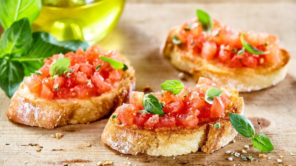 Bruschetta · Grilled garlic rubbed bread topped with chopped tomatoes, garlic, olive oil, and balsamic vinegar.
