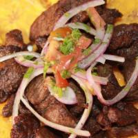 Carne De Res Frita / Fried Beef Tips · Carne Frita de Res acompañada de tostones.
Fried Beef tips accompanied with fried green plan...