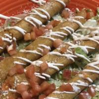 Flautas · Four corn tortillas filled with shredded chicken rolled, and deep fried. Served on a bed of ...