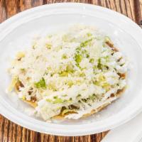 Tostada De Pollo · Crispy corn tortilla with shredded chicken breast, refried beans, lettuce, queso blanco, sou...