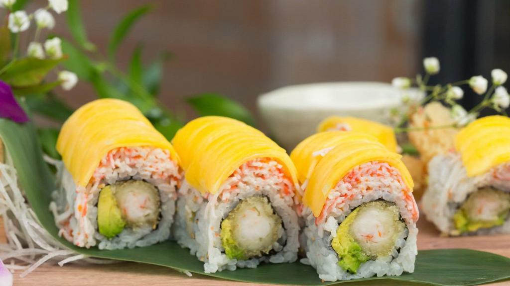 Golden Shrimp Roll · Inside: Shrimp tempura and avocado. Outside: Kani salad and mango. Sauce: Mango sauce.